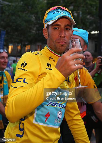Vincenzo Nibali of Italy and Astana Pro Team celebrates victory with a glass of champagne following the twenty first stage of the 2014 Tour de...