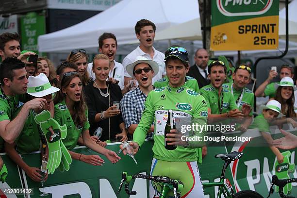 Peter Sagan of Slovakia and Cannondale celebrates winning the green jersey by opening a bottle of champagne with a glass following the twenty first...