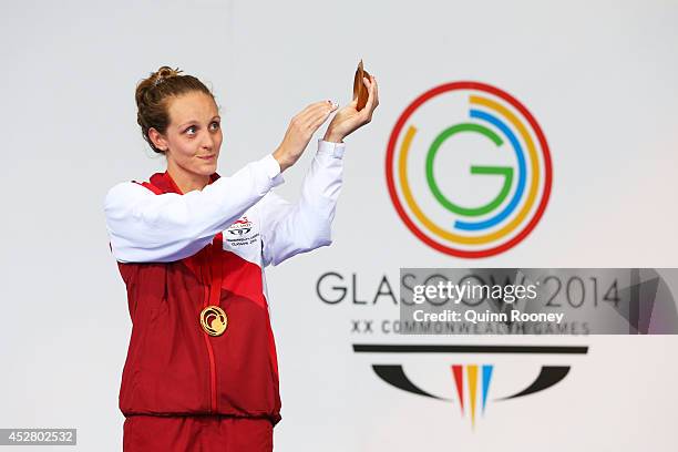 Gold medallist Francesca Halsall of England applauds the fans during the medal ceremony for the Women's 50m Butterfly Final at Tollcross...