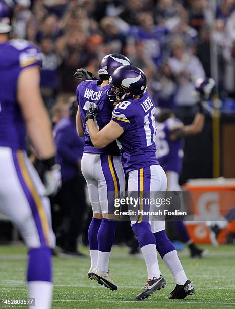 Blair Walsh and Jeff Locke of the Minnesota Vikings celebrate the game winning field goal during overtime of the game against the Chicago Bears on...