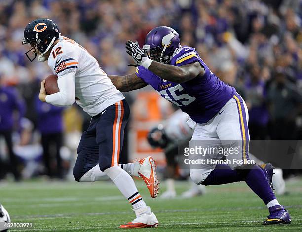 Josh McCown of the Chicago Bears scrambles with the ball as Sharrif Floyd of the Minnesota Vikings gives chase during the fourth quarter of the game...