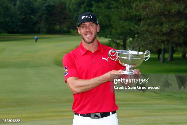 Graham DeLaet of Canada holds the Rivermead Cup as low Canadian winner at the RBC Canadian Open at the Royal Montreal Golf Club on July 27, 2014 in...