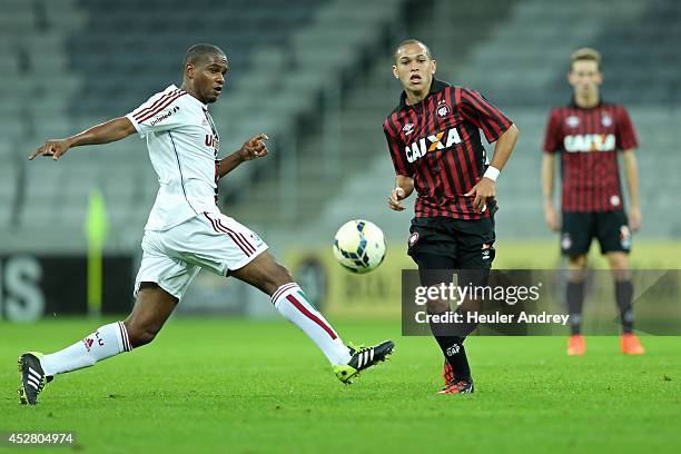 Marcos Guilherme of Atletico-PR competes for the ball with Valencia of Fluminense during the match between Atletico-PR and Fluminense for the...