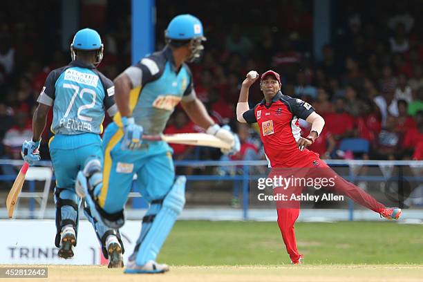 Samuel Badree fields as Andre Fletcher and Keddy Lesporis take a single during a match between The Trinidad and Tobago Red Steel and St. Lucia Zouks...