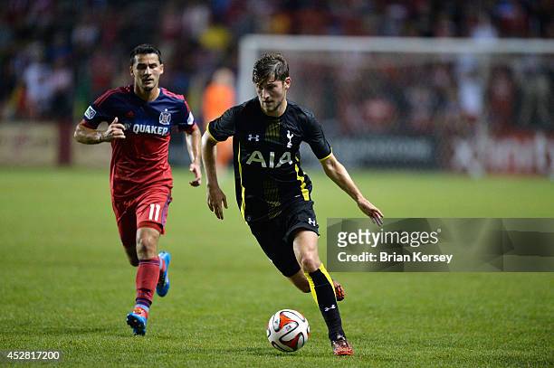 Ben Davies of Tottenham Hotspur moves the ball as Dilly Duka of the Chicago Fire defends during the second half at Toyota Park on July 26, 2014 in...