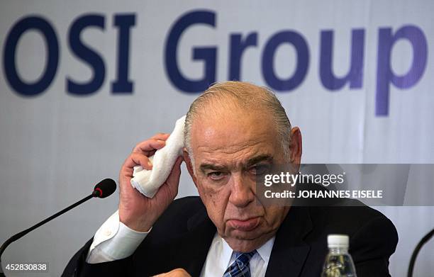 Sheldon Lavin, CEO of the OSI Group, gestures as he attends a press conference over the recent expired meat scandal in Shanghai on July 28, 2014....