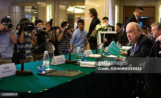 Members of the media focus on Sheldon Lavin , CEO of the OSI Group, as he leaves a press conference about the recent expired meat scandal in Shanghai...