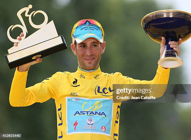 Vincenzo Nibali of Italy and Astana Pro Team celebrates winning the yellow jersey on the podium, following the twenty one and last stage of the 2014...
