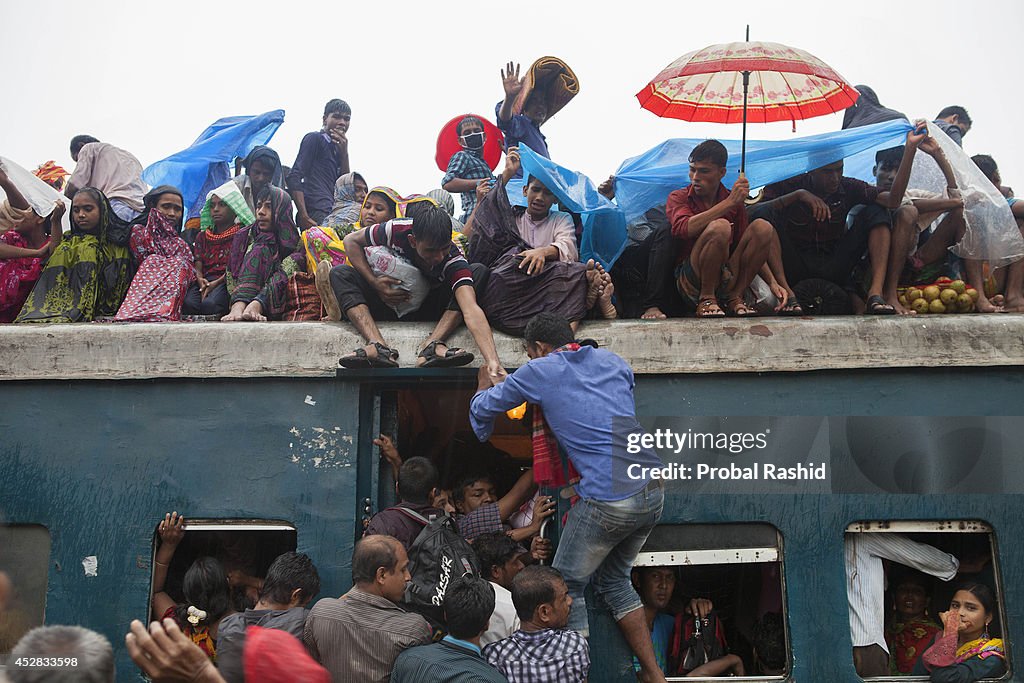 Bangladeshi people travel on the roof of an overcrowded...