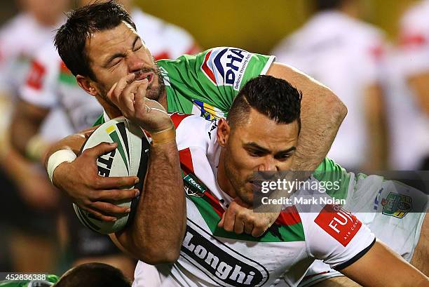 Ben Te'o of the Rabbitohs is tackled during the round 20 NRL match between the Canberra Raiders and the South Sydney Rabbitohs at GIO Stadium on July...