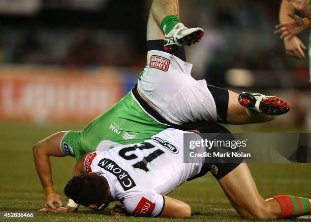 Ben Te'o of the Rabbitohs tackles Jarrod Croker of the Raiders on his head during the round 20 NRL match between the Canberra Raiders and the South...