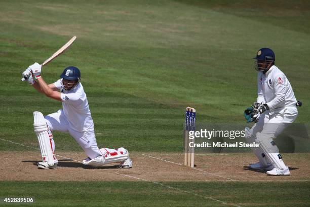 Gary Ballance of England hits a cover drive as wicketkeeper MS Dhoni of India looks on during day two of the 3rd Investec Test match between England...