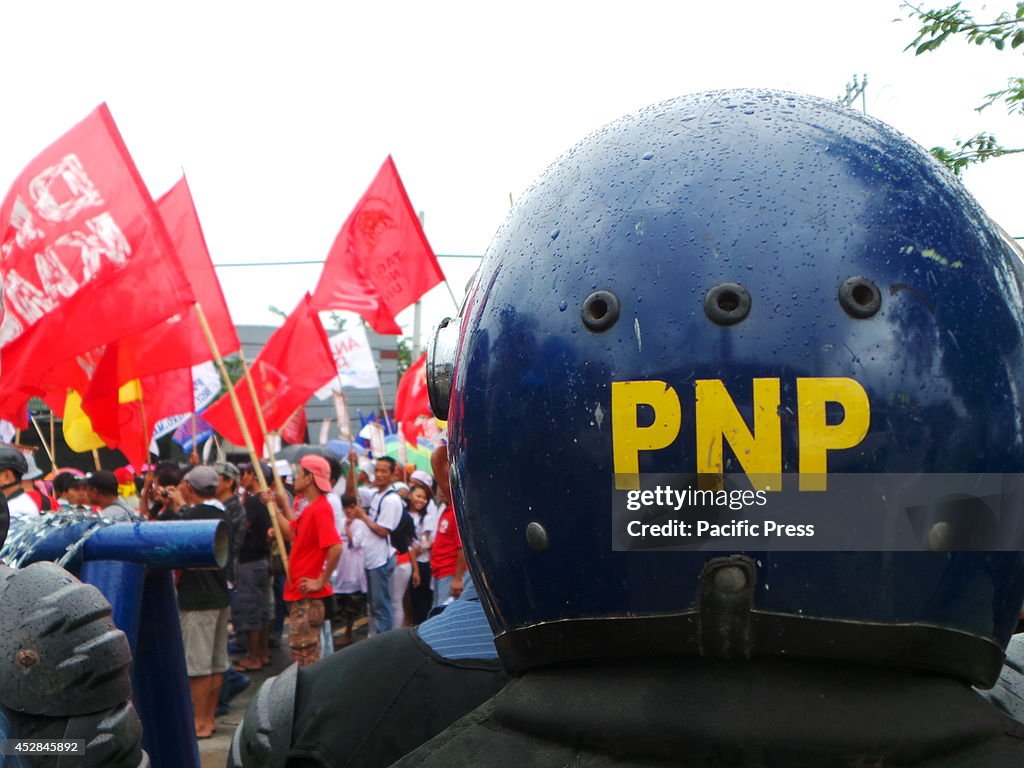 Policemen monitor the demonstrators during the Fifth State...