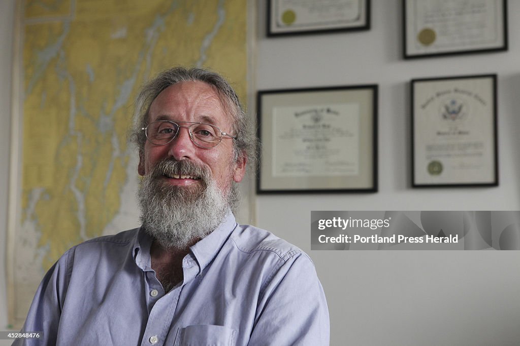 Matt Dyer, survior or a poloar bear attack, poses in his office