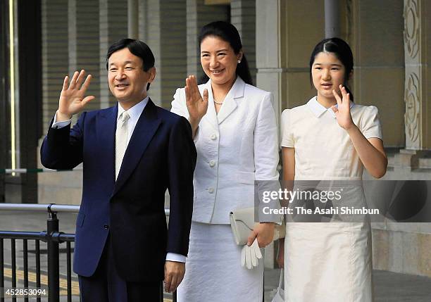 Crown Prince Naruhito, Crown Princess Masako and Princess Aiko wave to well-wishers upon arrival at Ujiyamada station on July 28, 2014 in Ise, Mie,...