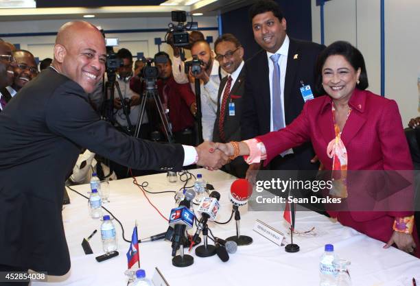 Michel Martelly , President of Haiti and Kamla Persad-Bissessar, Prime Minister of Trinidad and Tobago pose after signing business development...