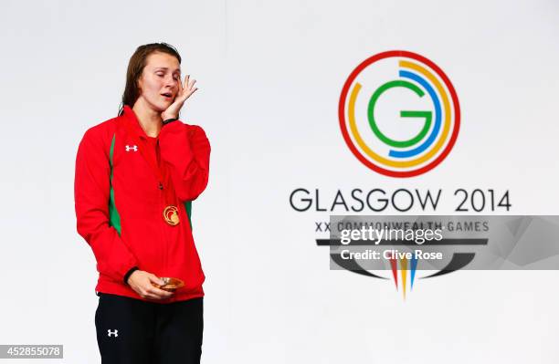 Gold medallist Jazz Carlin of Wales wipes away tears during the medal ceremony for the Women's 800m Freestyle Final at Tollcross International...