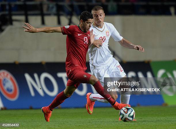 Portugal's forward Ivo Rodrigues vies with Serbia's midfielder Sergej Milinkovic-Savic during a football match of the UEFA Under-19 European...