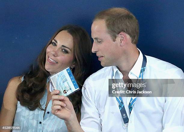 Catherine, Duchess of Cambridge is fanned in the heat of Tollcross Swimming Centre by Prince William, Duke of Cambridge and a Games Volunteer as they...