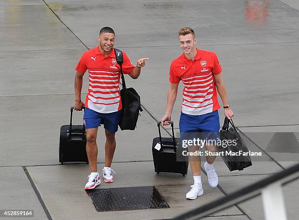 Arsenal's Alex Oxlade-Chamberlain and Calum Chambers board the team flight for Austria at Luton Airport on July 28, 2014 in Luton, England.