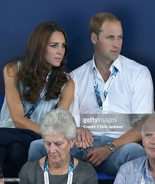 Catherine, Duchess of Cambridge and Prince William, Duke of Cambridge hold hands as they watch the swimming at Tollcross Swimming Centre during the...