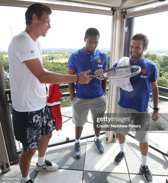 Juan Mata and Antonio Valencia of Manchester United meet tennis player Tomas Berdych who is playing in the Citi Open, at their hotel on July 28, 2014...