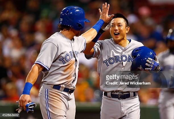 Munenori Kawasaki of the Toronto Blue Jays is congratulated by teammate Colby Rasmus after scoring in the fourth inning against the Boston Red Sox...