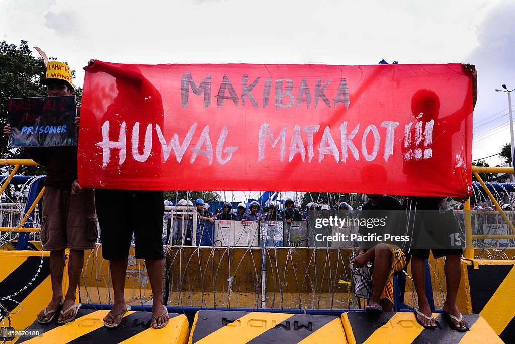 A group of demonstrators   spread their banner saying ,"Dare...