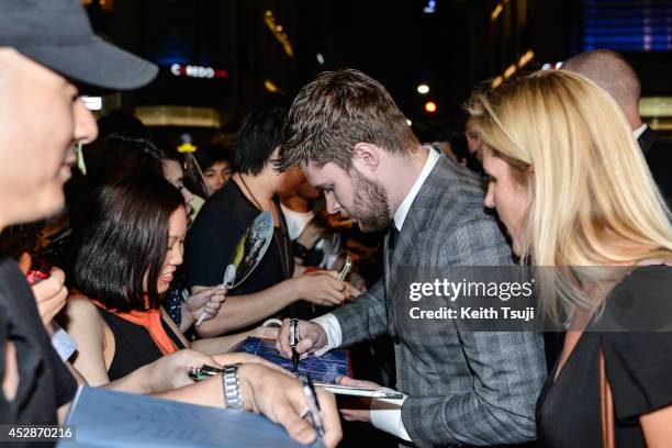 Jack Reynor signs autographs for fans at the Japan premiere of 'Transformers : Age Of Extinction' at the Toho Cinemas Nihonbashi on July 28, 2014 in...