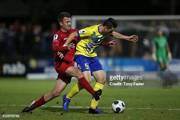 Peter Haynes of Broadmeadow contests the ball with Scot Coulson of Brisbane during the FFA Cup match between Broadmeadow and Brisbane Strikers at...