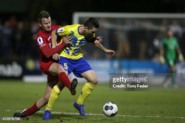 Peter Haynes of Broadmeadow contests the ball with Scot Coulson of Brisbane during the FFA Cup match between Broadmeadow and Brisbane Strikers at...