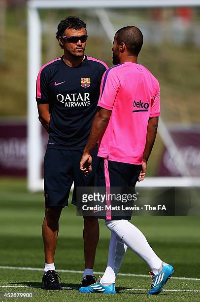 Luis Enrique, manager of Barcelona talks to Rafa Alcântara during a Barcelona Training Session at St Georges Park on July 29, 2014 in...