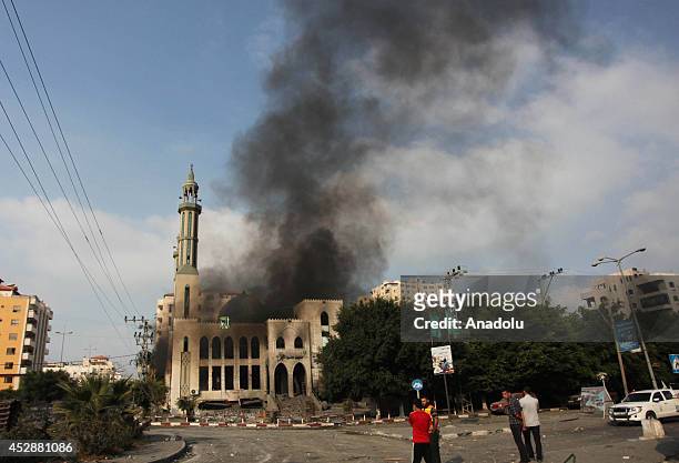Smoke rises from El-Emin Mohammed mosque after an Israeli air strike in Gaza City, Gaza on July 29, 2014. Israeli army said Tuesday that its forces...