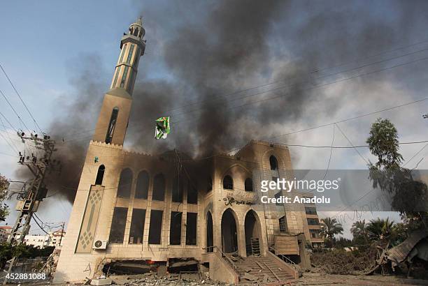 Smoke rises from El-Emin Mohammed mosque after an Israeli air strike in Gaza City, Gaza on July 29, 2014. Israeli army said Tuesday that its forces...
