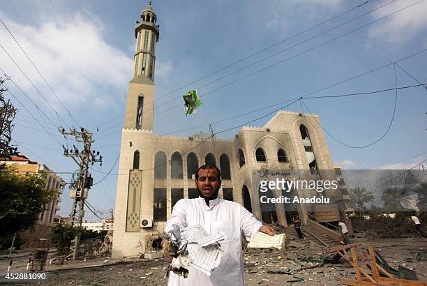 Palestinian man reacts after an Israeli air strike hits El-Emin Mohammed mosque in Gaza City, Gaza on July 29, 2014. Israeli army said Tuesday that...