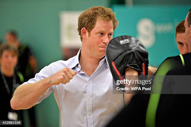 Prince Harry tries his hand at boxing as he and Prince William, Duke of Cambridge visit a Coach Core project at Gorbals Leisure Centre on July 29,...