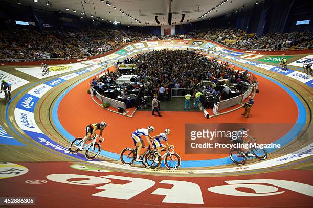 Professional cyclists competing in the Six Days Of Ghent cycling event at the Kuipke velodrome in Ghent, Belgium, on November 22, 2013.