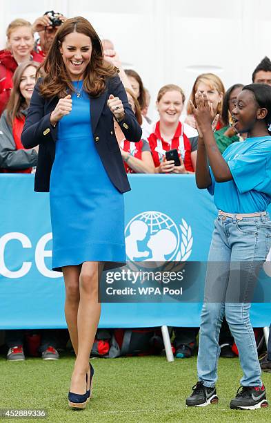 Catherine, Duchess of Cambridge plays the South African game of Three Tins during a visit to the Commonwealth Games Village on July 29, 2014 in...