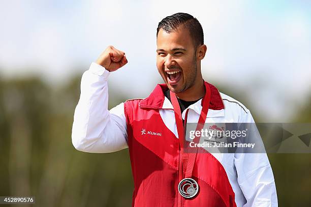 Aaron Heading of England celebrates winning Silver in the Trap final at Barry Buddon Shooting Centre during day six of the Glasgow 2014 Commonwealth...