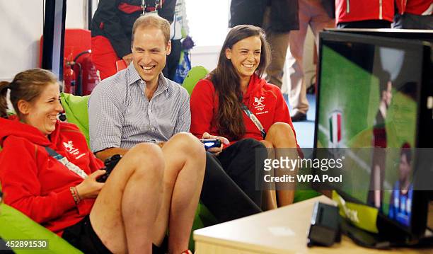 Prince William, Duke of Cambridge plays a computer game during a visit to the Commonwealth Games Village on July 29, 2014 in Glasgow, Scotland.