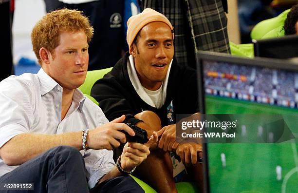 Prince Harry plays a computer game during a visit to the Commonwealth Games Village on July 29, 2014 in Glasgow, Scotland.