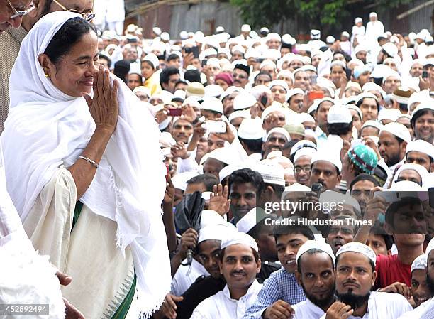 West Bengal Chief Minister Mamata Banerjee greets Muslims during prayers on the occasion of Eid-ul-fitr at Red Road on July 29, 2014 in Kolkata,...