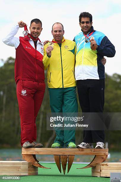 Gold medalist Adam Vella of Australia, Silver medalist Aaron Heading of England and Bronze medalist Manavjit Sandhu of India after the Trap final at...