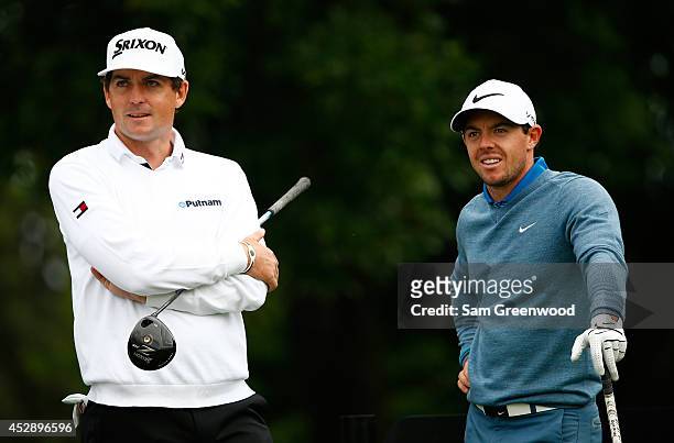 Keegan Bradley speaks with Rory McIlroy of Ireland during a practice round for the World Golf Championships-Bridgestone Invitational at Firestone...