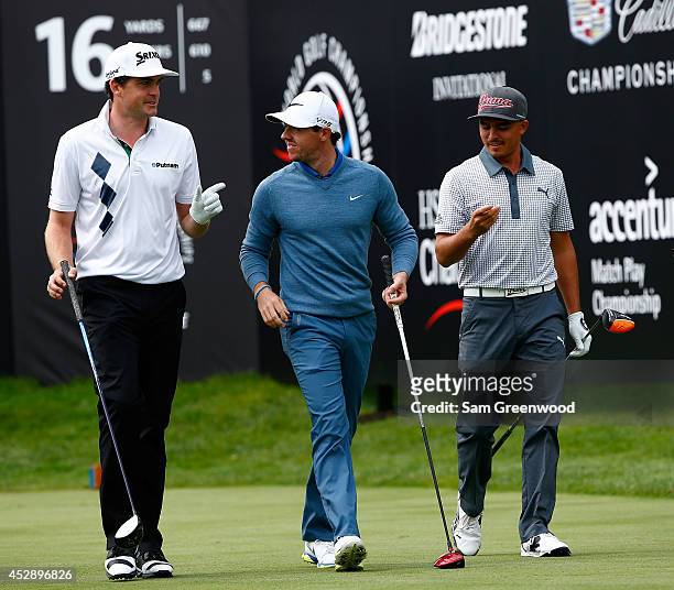 Keegan Bradley , Rory McIlroy of Ireland and Rickie Fowler walk down the 16th hole during a practice round for the World Golf...