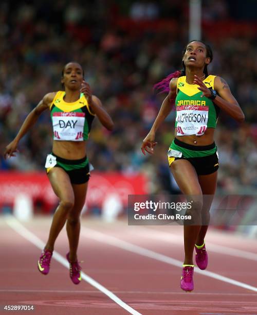 Stephanie McPherson of Jamaica crosses the line to win gold ahead of Christine Day of Jamaica in the Women's 400 metres final at Hampden Park during...