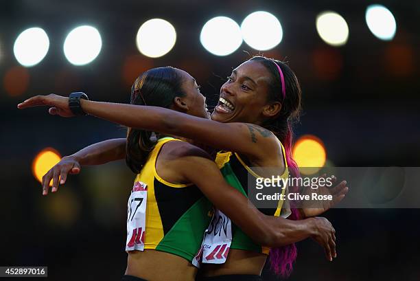 Stephanie McPherson of Jamaica is congratulated on winning gold by bronze medalist Christine Day of Jamaica in the Women's 400 metres final at...