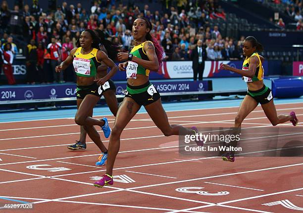 Silver medalist Novlene Williams-Mills of Jamaica, gold medalist Stephanie McPherson of Jamaica and bronze medalist Christine Day of Jamaica cross...