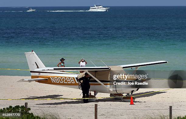 Cessna airplane is seen on the beach after its pilot made an emergency landing on July 29, 2014 in Miami Beach, Florida. No injuries were reported to...