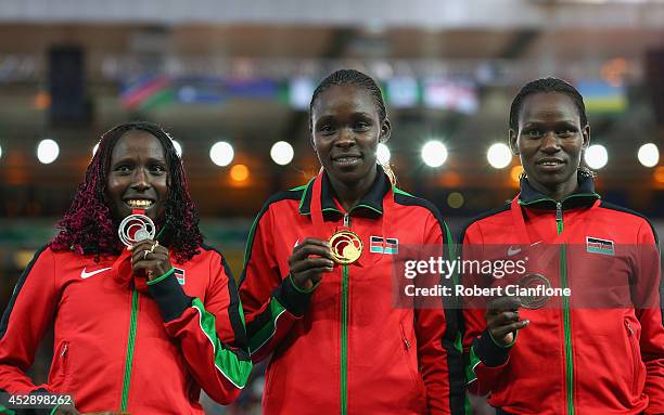 Silver medallist Florence Kiplagat of Kenya , Gold medallist Joyce Chepkirui of Kenya and bronze medallist Emily Chebet of Kenya pose on the podium...
